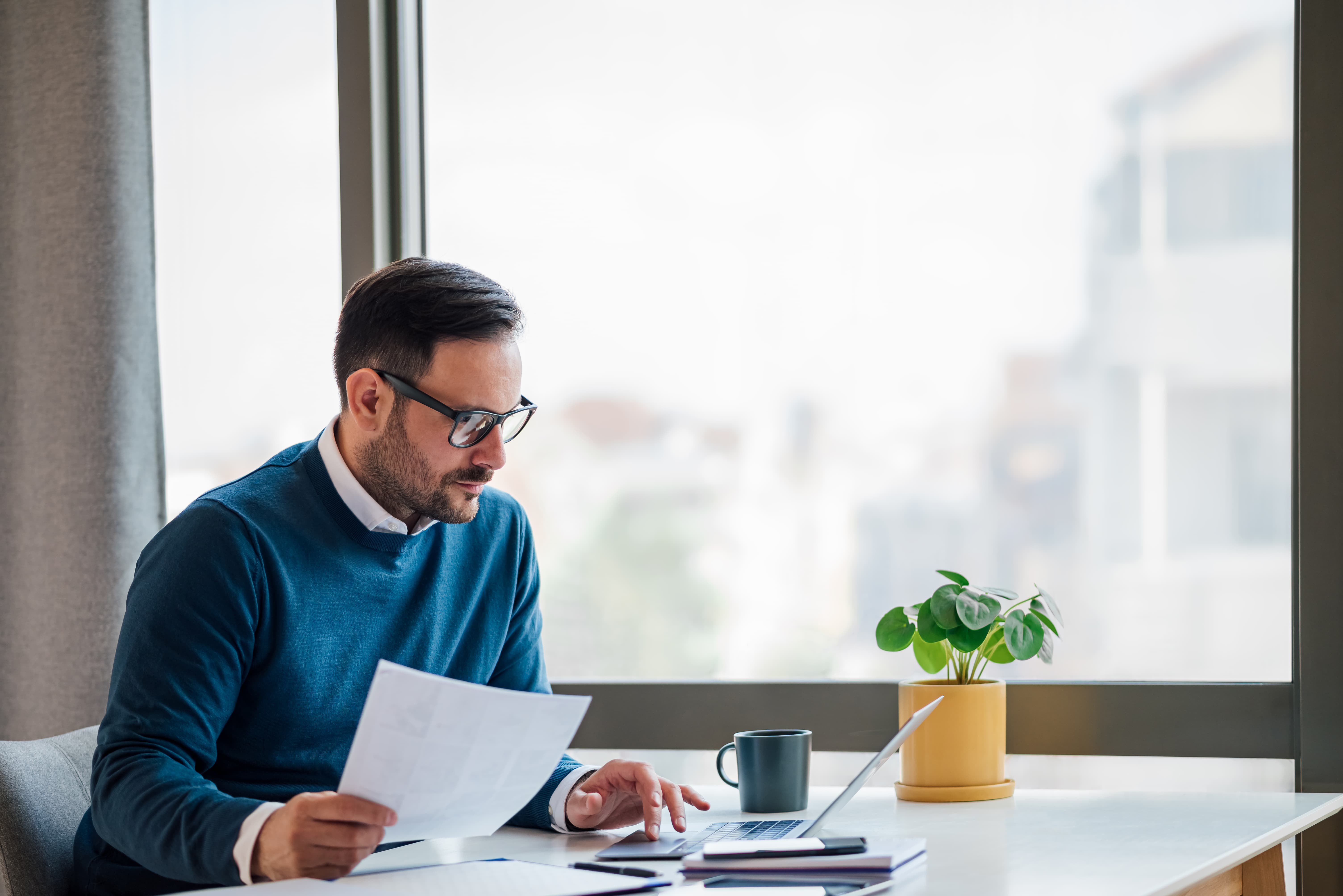 Concentrated business manager, checking the resume of potential employee.