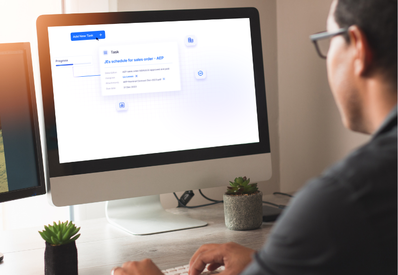 men sitting in front of a computer looking at nominal platform
