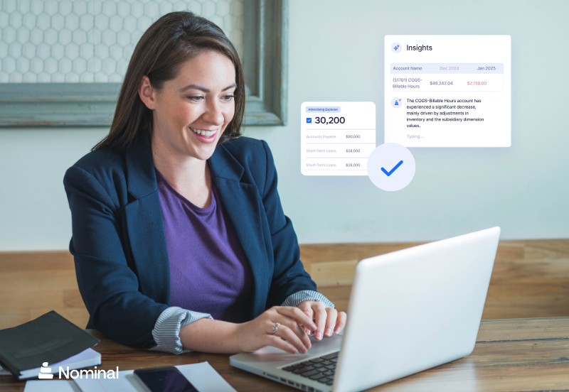 woman smiling looking at computer with nominal dashboards n the screen