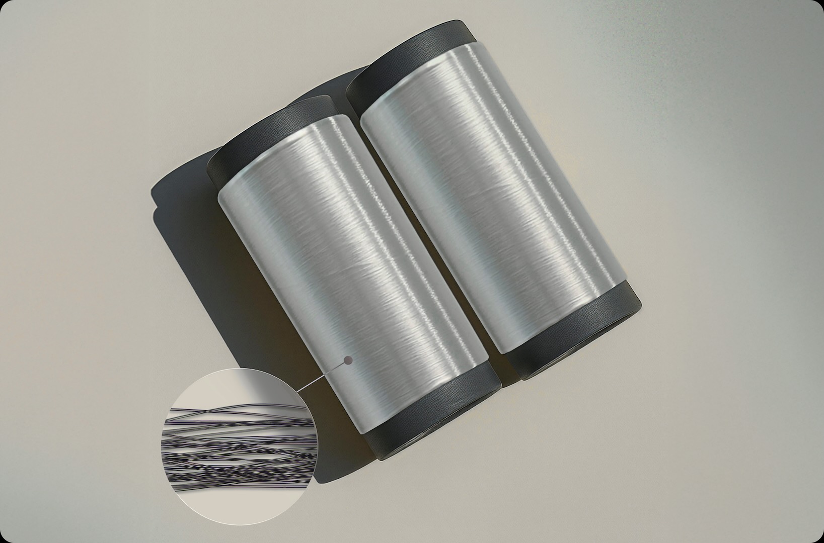 Two spools of fibre with high lustre, with a magnified inset showing fine individual filaments.