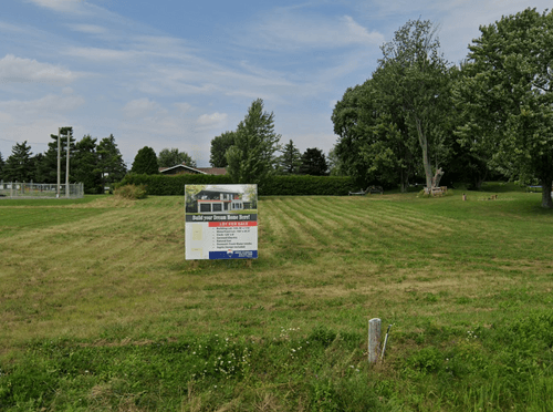Empty lot with for sale sign