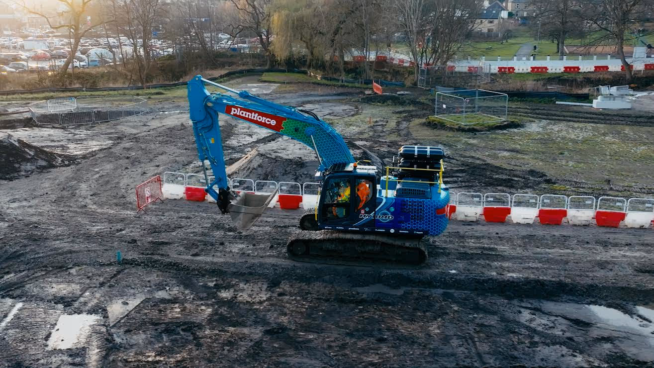 Engineer inspecting a machine on a construction site.