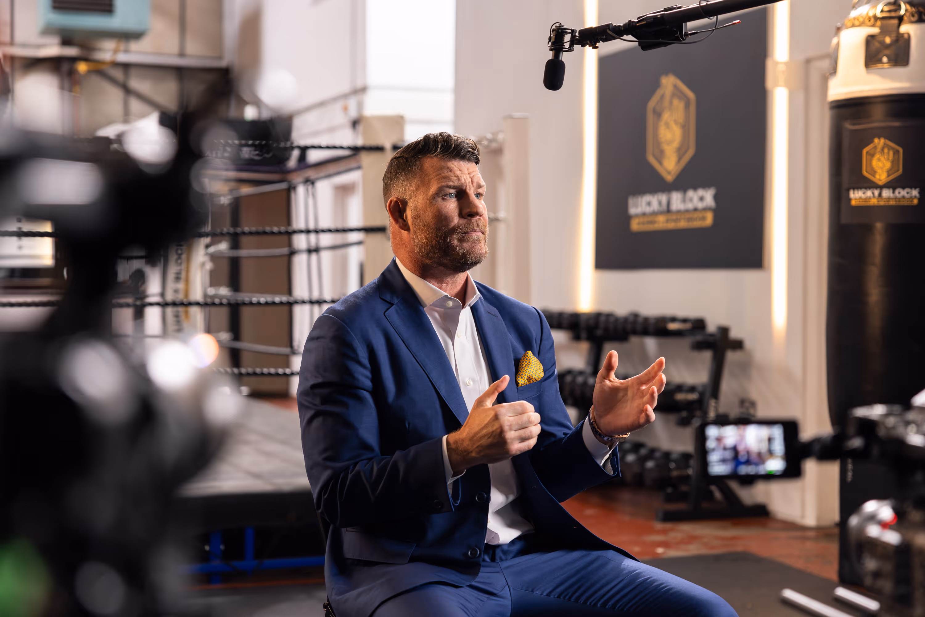 Michael Bisping being interviewed on set. There are cameras and a microphone in the foreground
