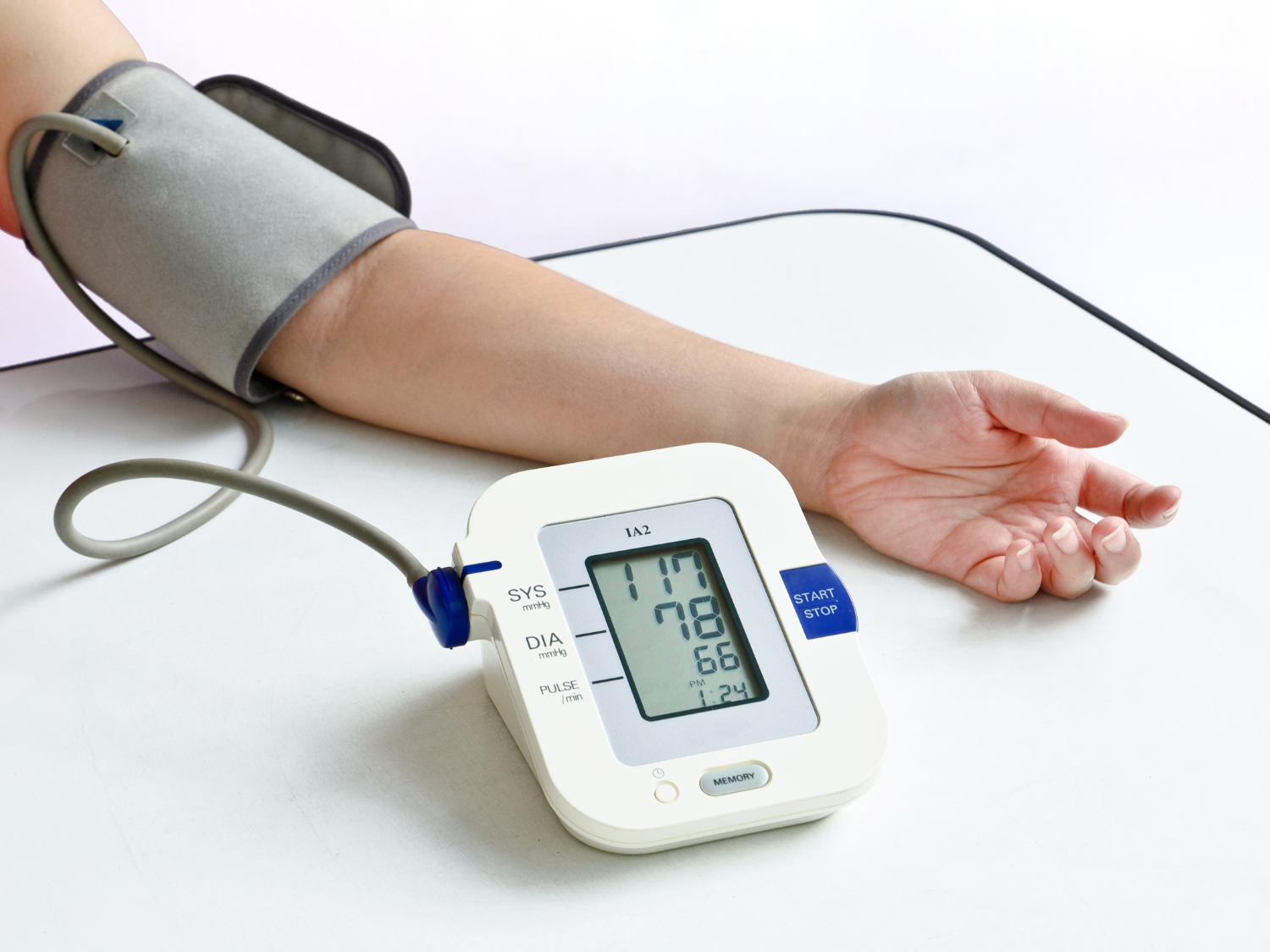 A patient receives a blood pressure screen using a blood pressure cuff and monitor.