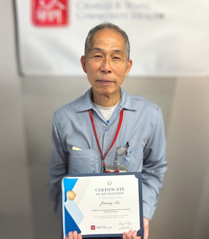 custodian holding staff spotlight certificate