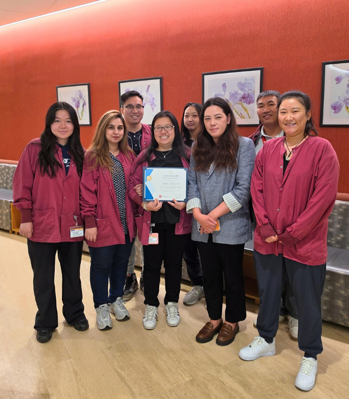 group of dental PSR surrounding Judy holding her certificate of recognition