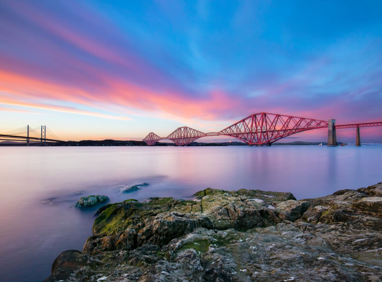 Scenic picture of the Forth Bridge with a pink sunset