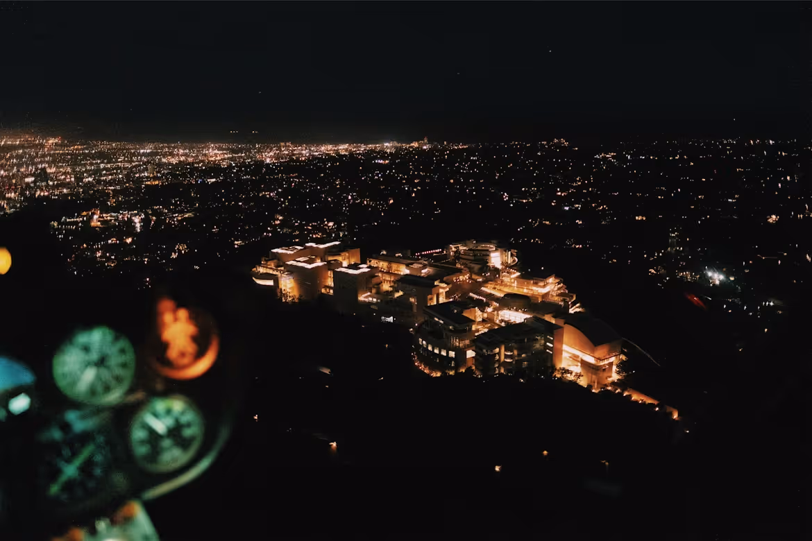 nighttime aerial view of a city from inside a helicopter cockpit