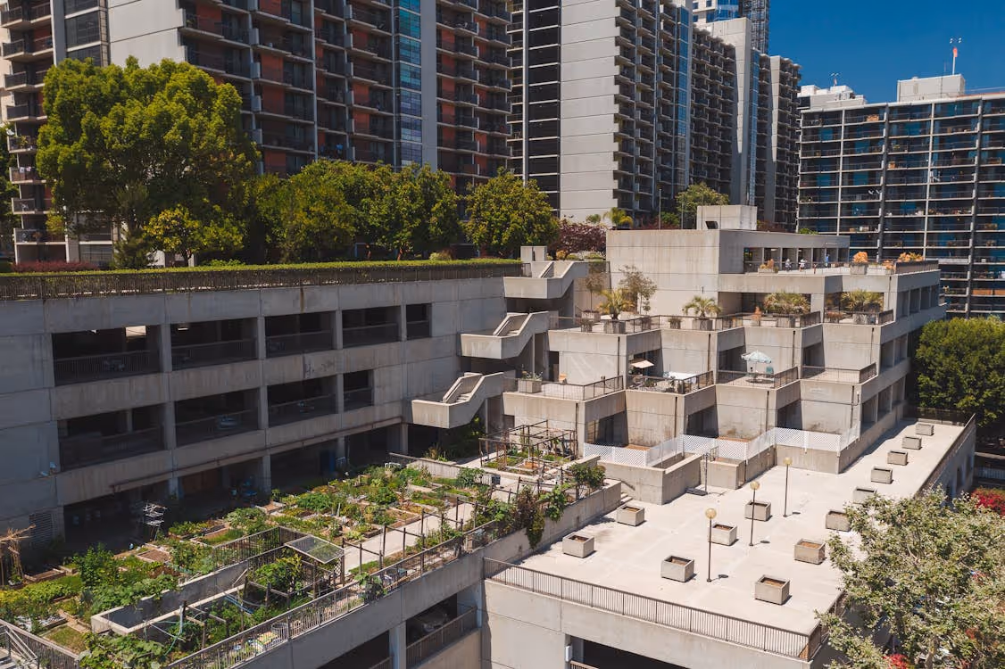 aerial view of a rooftop garden on a concrete building near high-rise apartments in Los Angeles
