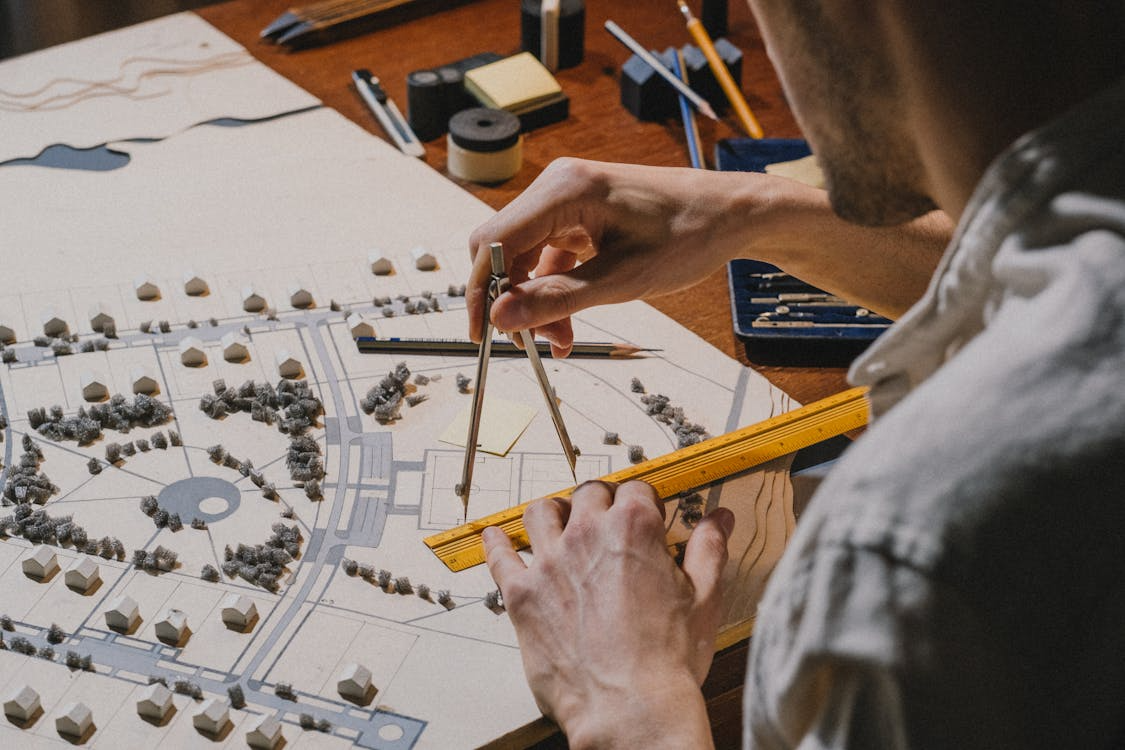 architect working with a ruler and city planning model