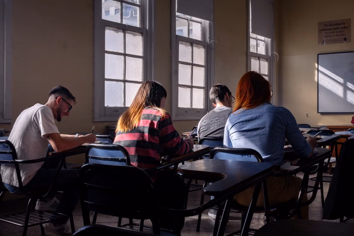students in a classroom with natural light taking a test