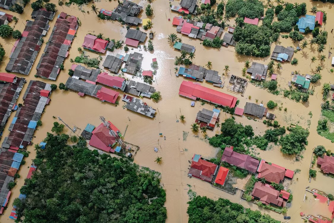 aerial shot showing a residential neighborhood submerged in floodwater after torrential rains