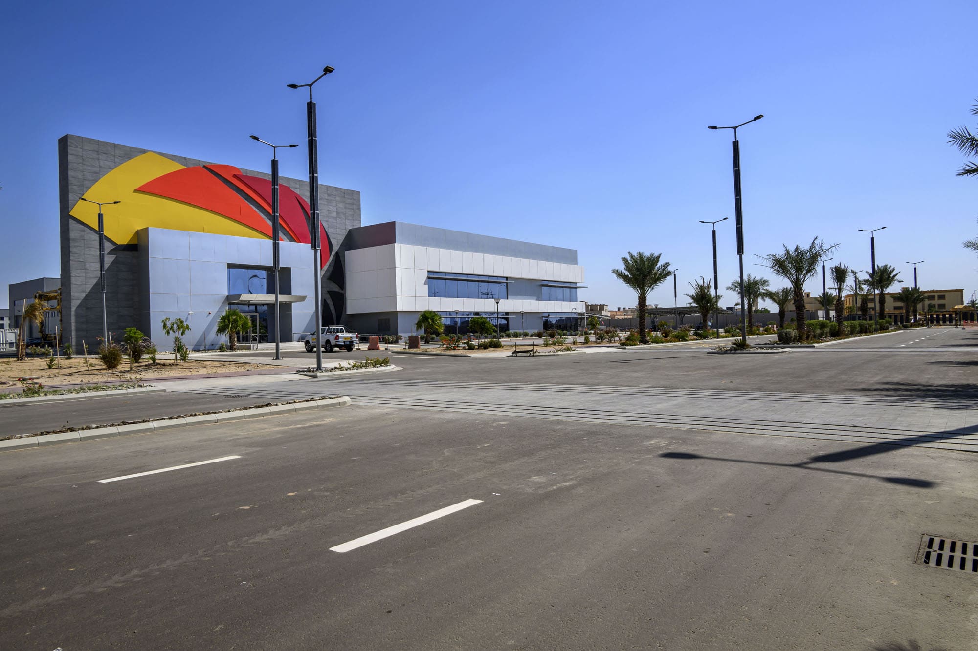 Exterior of Zahid Business Park — administrative and maintenance buildings with 50m water tank landmark, Saudi Arabia. Delivered by OCC Weavers.