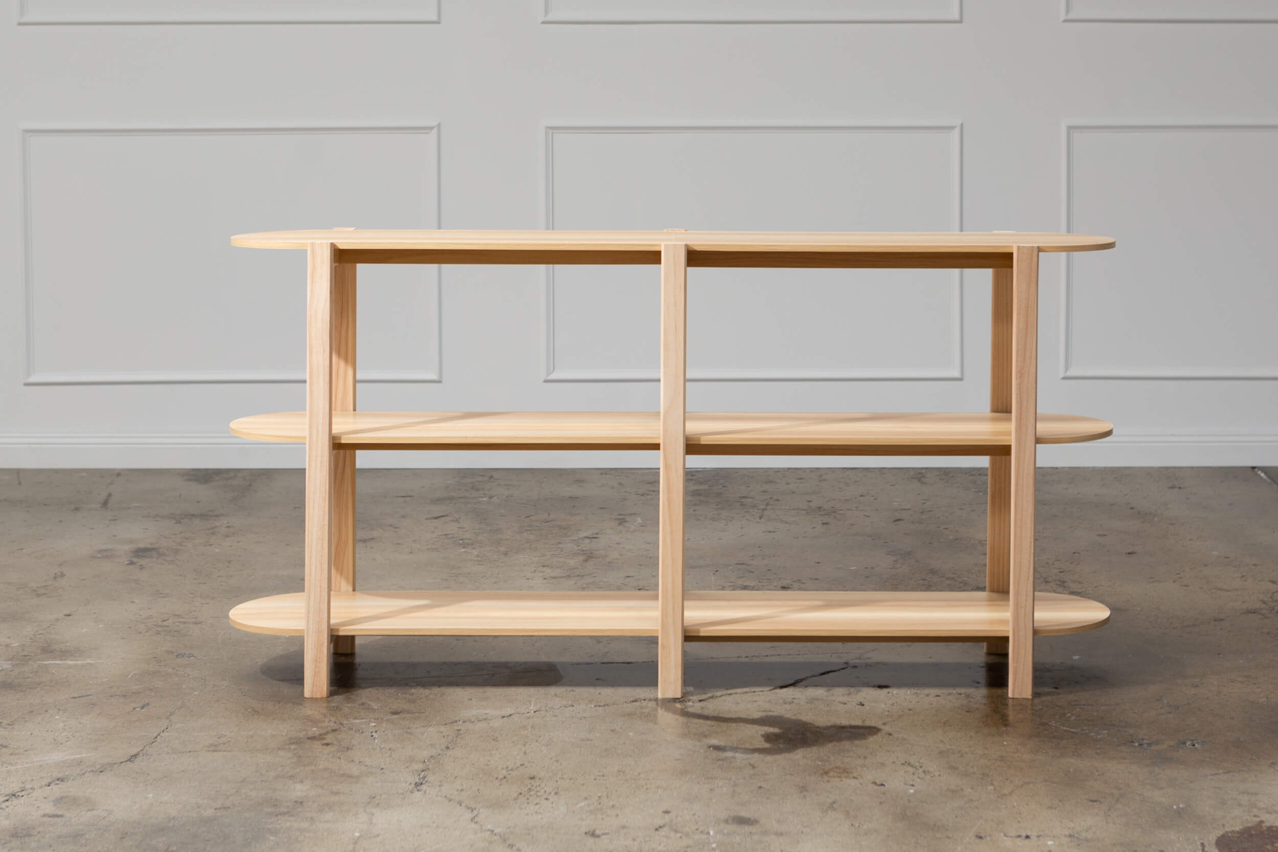 Natural wood sideboard for a creative photoshoot.