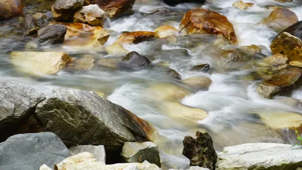 a close up of a river with rocks and water