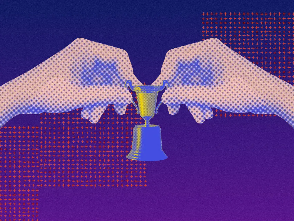 An image showing hands holding a small trophy, indicating celebrating the small wins