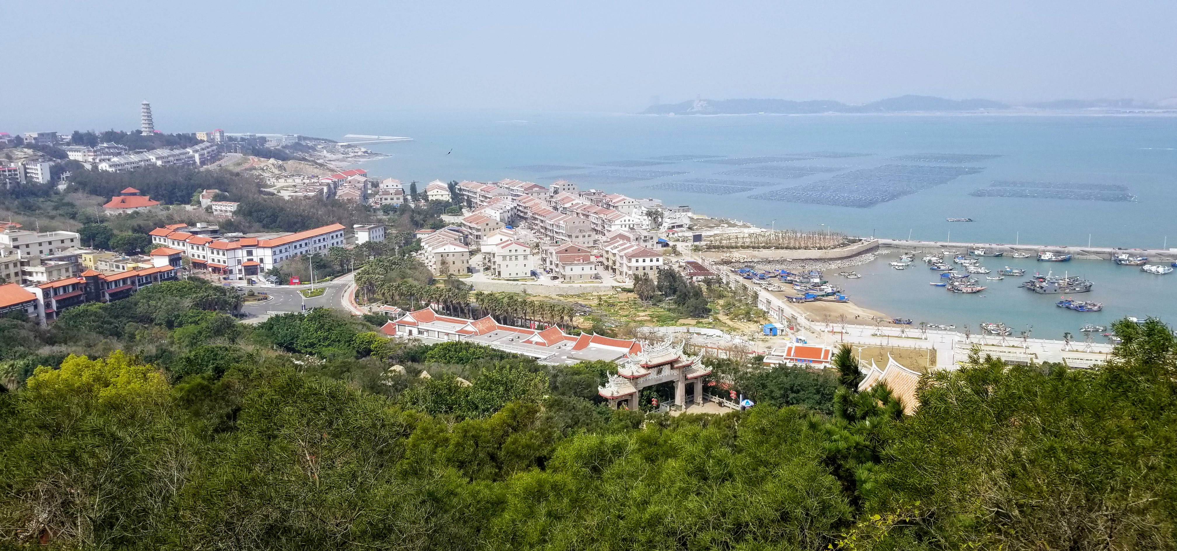 Meizhou harbor, fishing boats, coastal buildings, and open water
