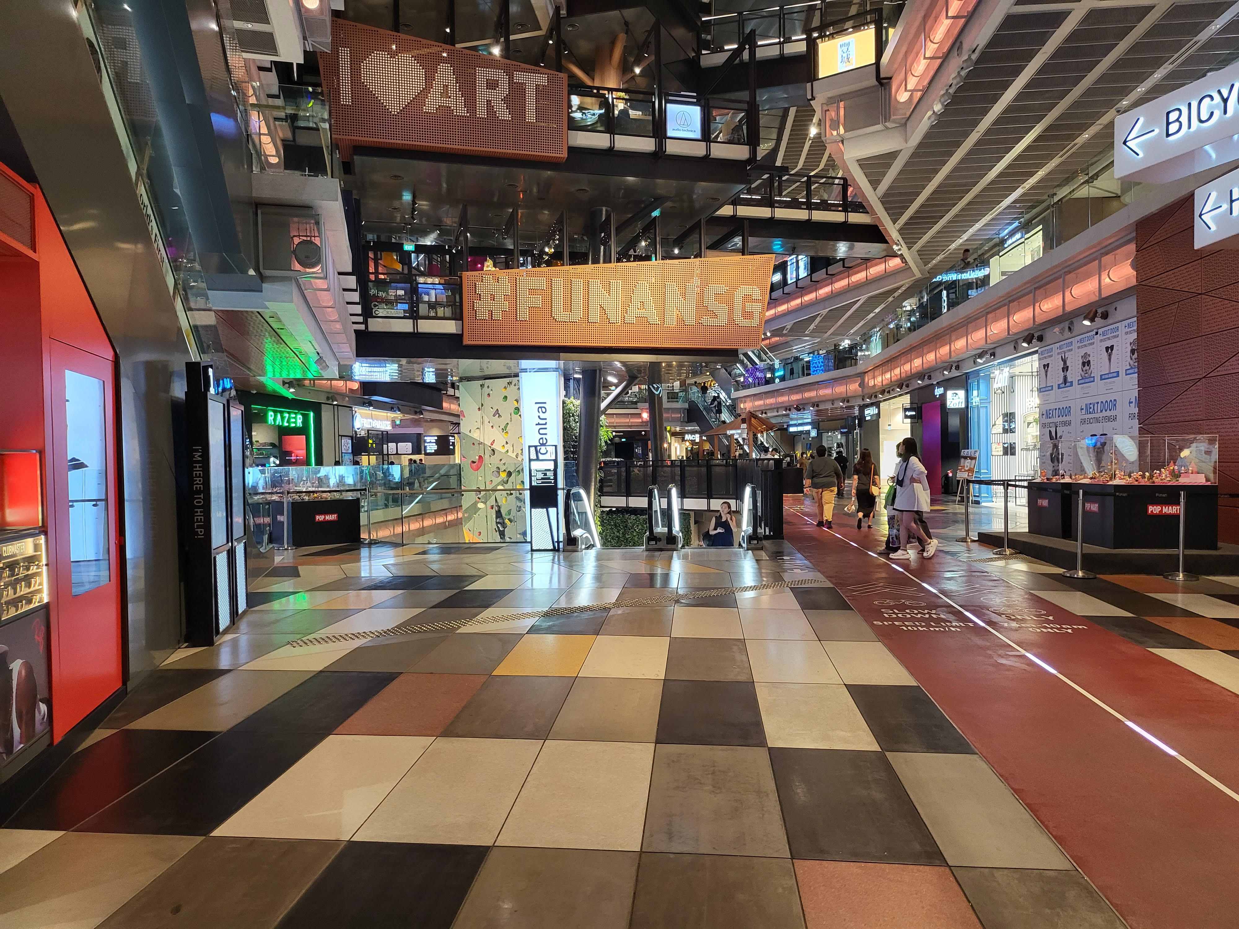 The colorful interior walkways and storefronts at Funan