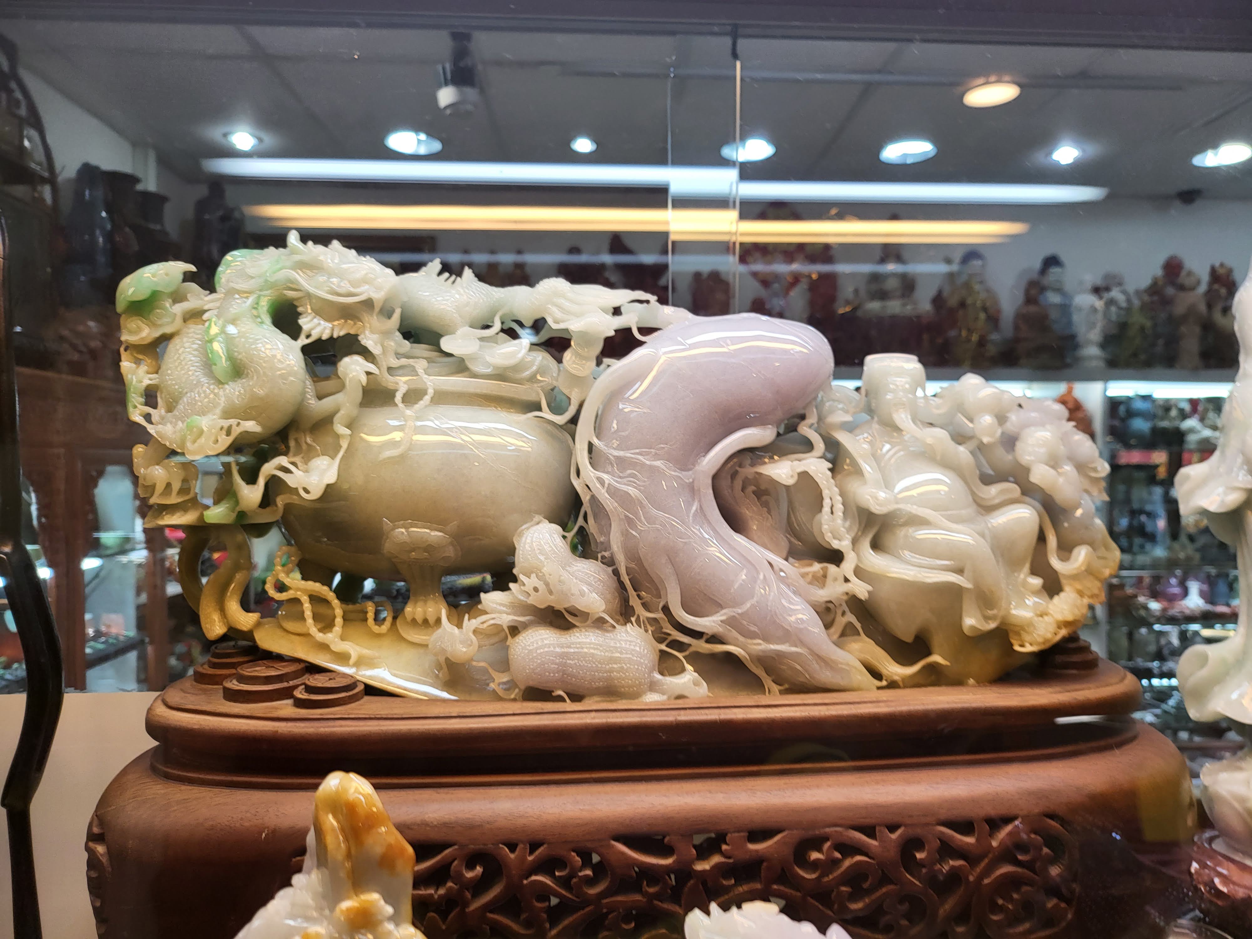 An elaborate pale carved object displayed in a shop