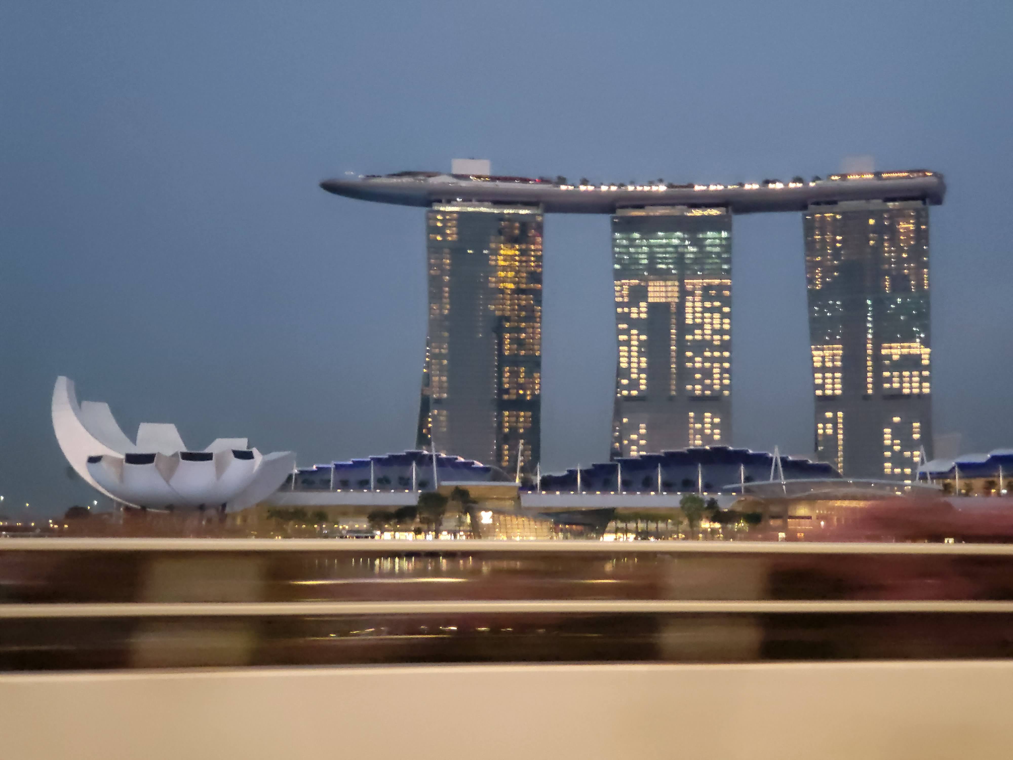 Marina Bay Sands illuminated across the water at dusk