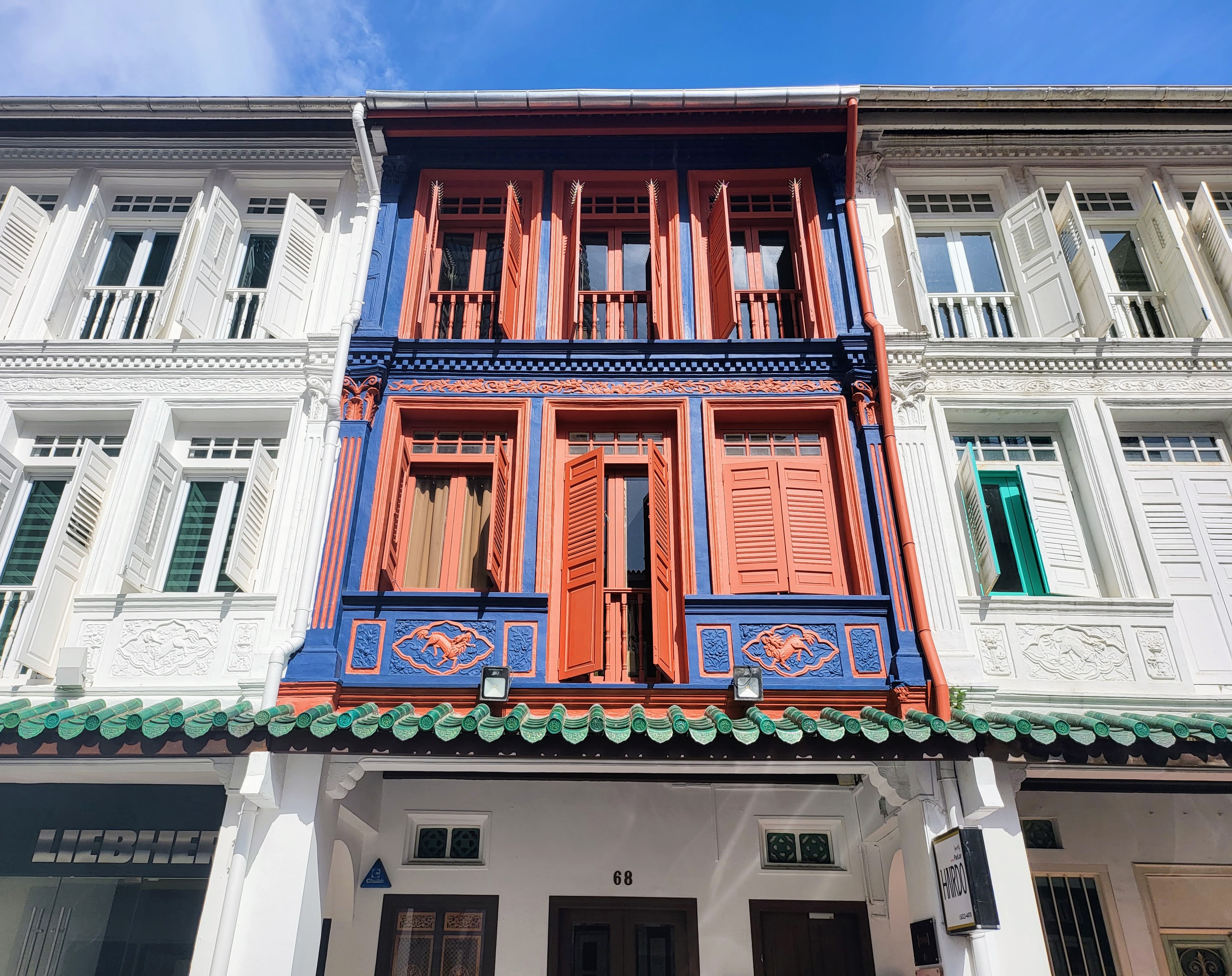 Colorful shutters on a row of Singapore shophouses