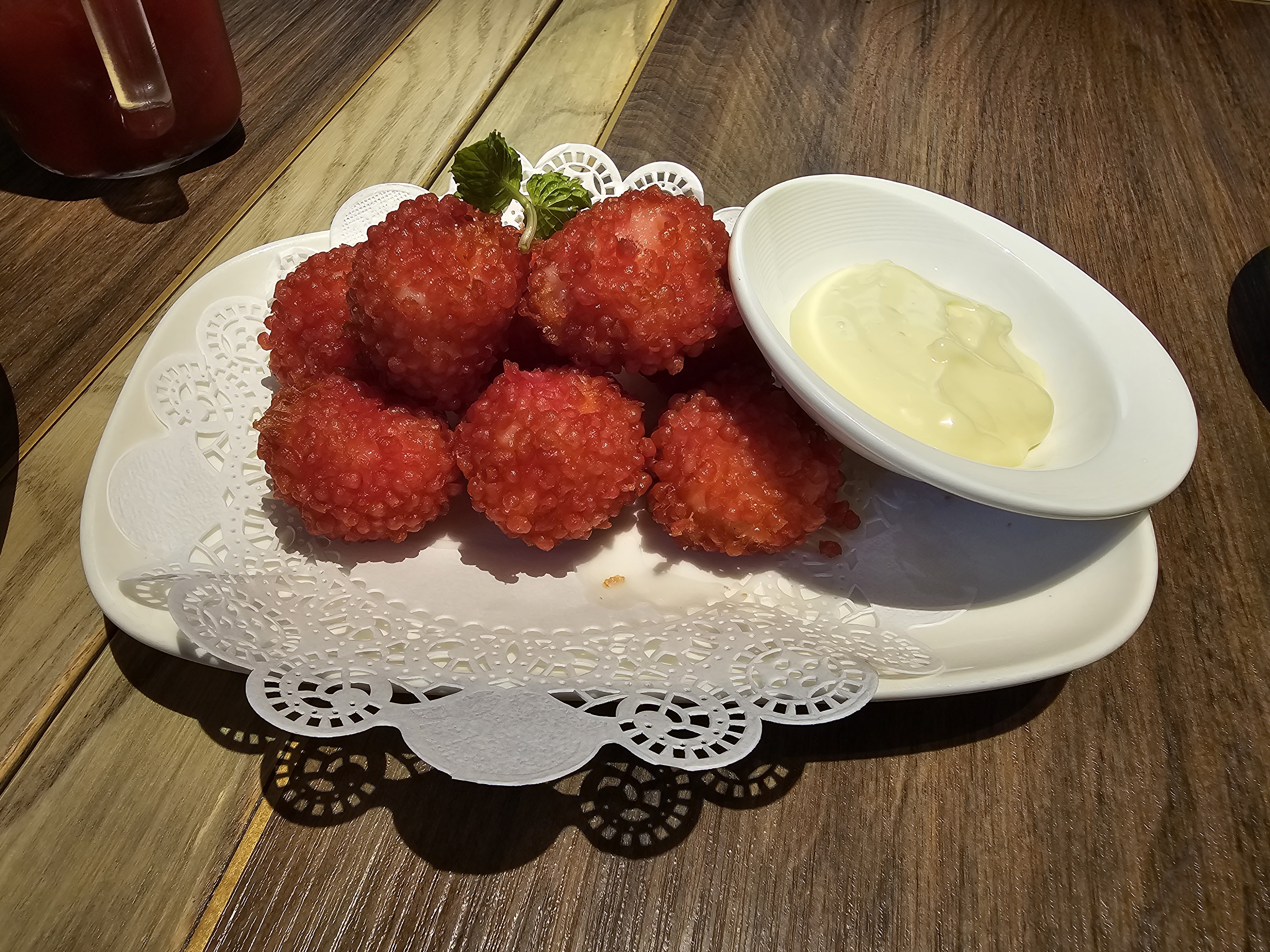 Crisp red-coated bites with a pale dipping sauce