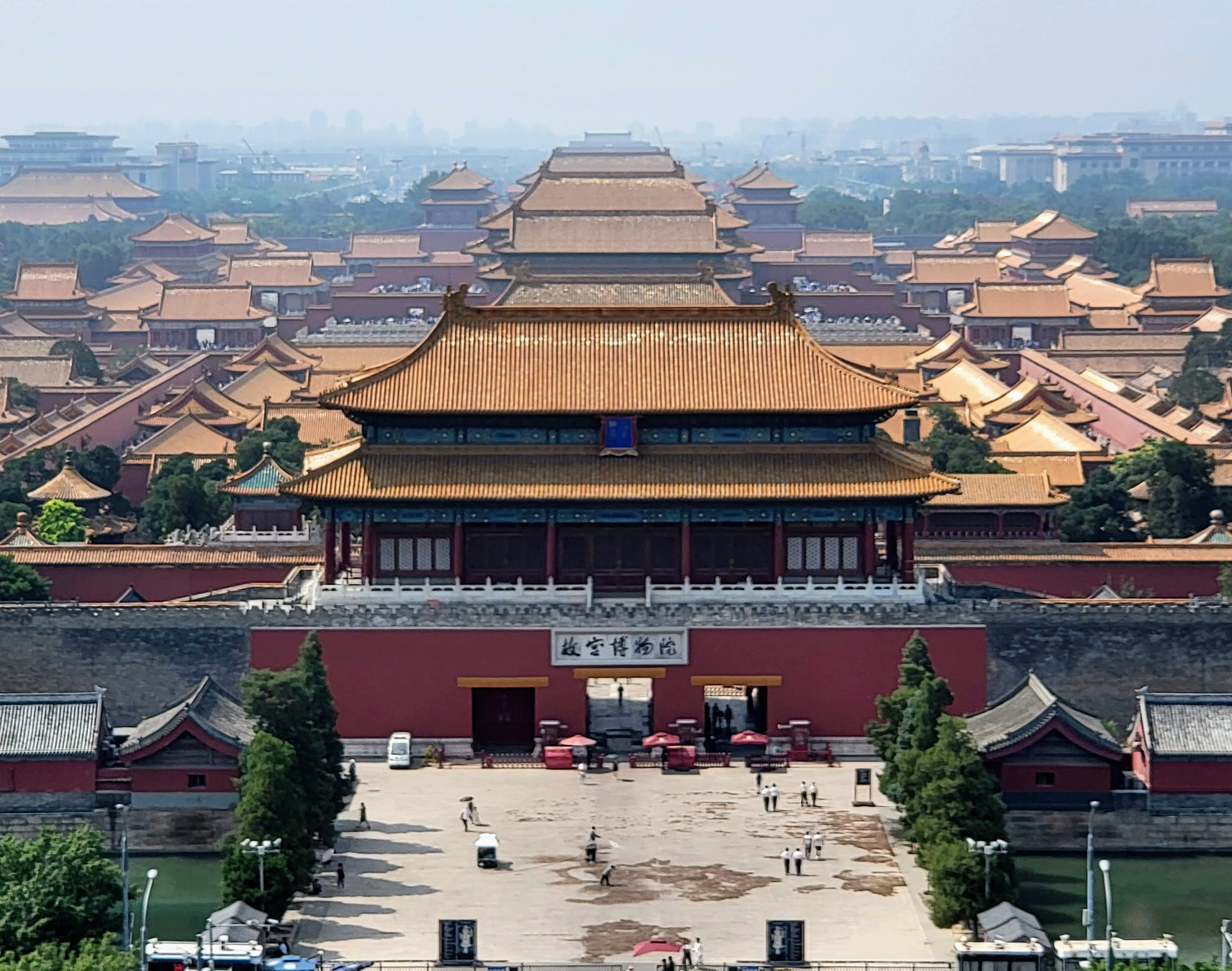 The Forbidden City stretches along its central axis beneath a succession of golden roofs, seen from Jingshan Park.