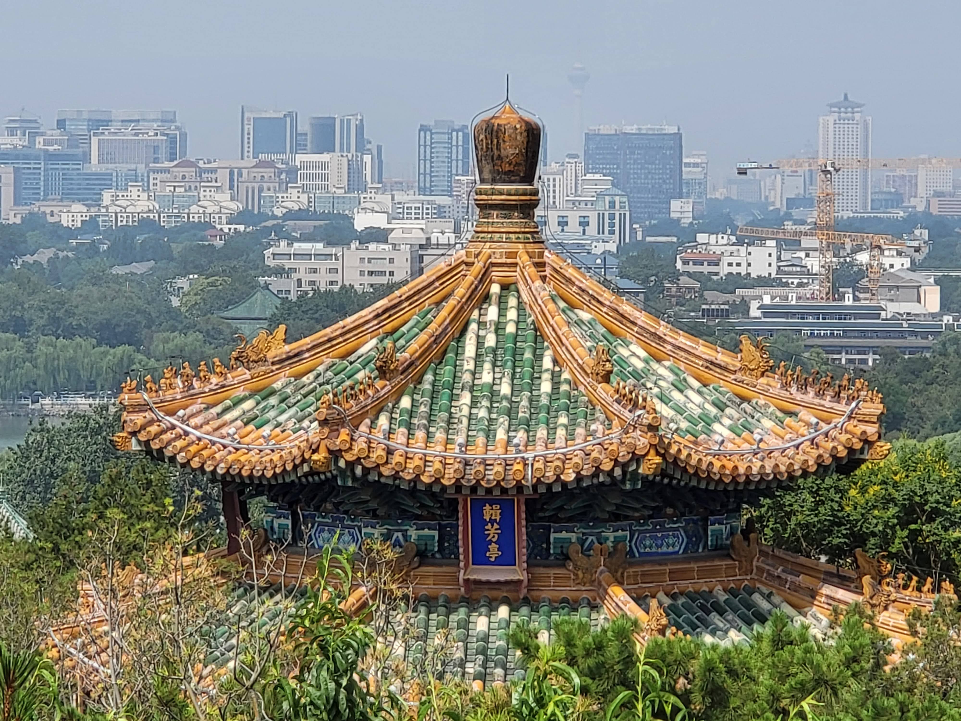 A glazed-roof pavilion overlooks Beijing from Jingshan Park.