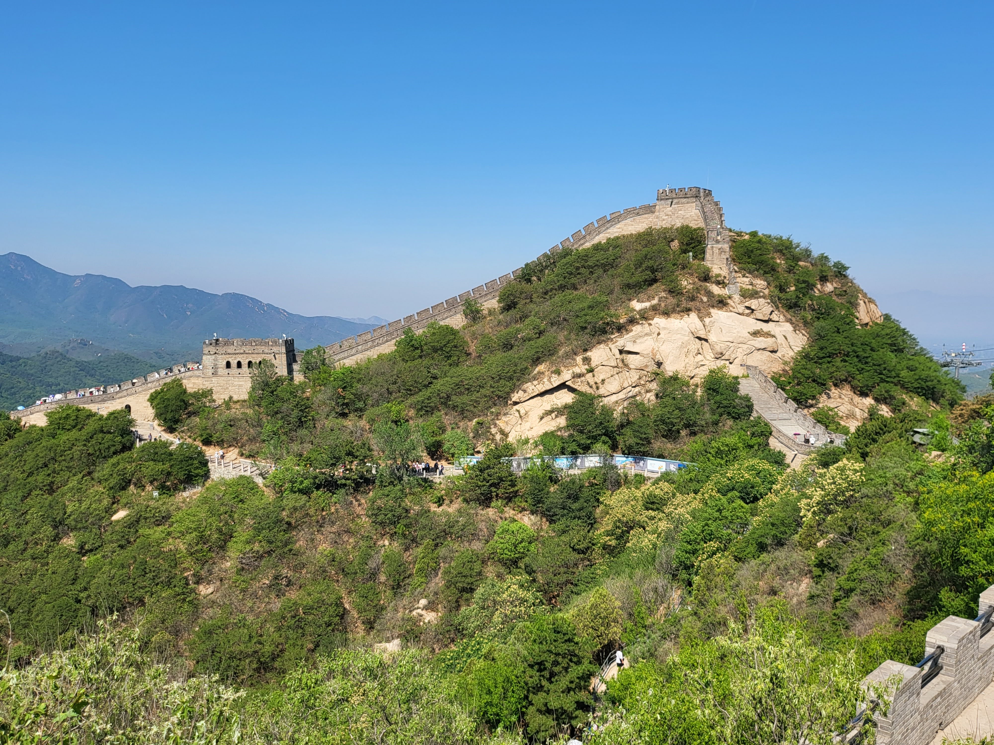 A watchtower crowns the ridge above a long staircase.