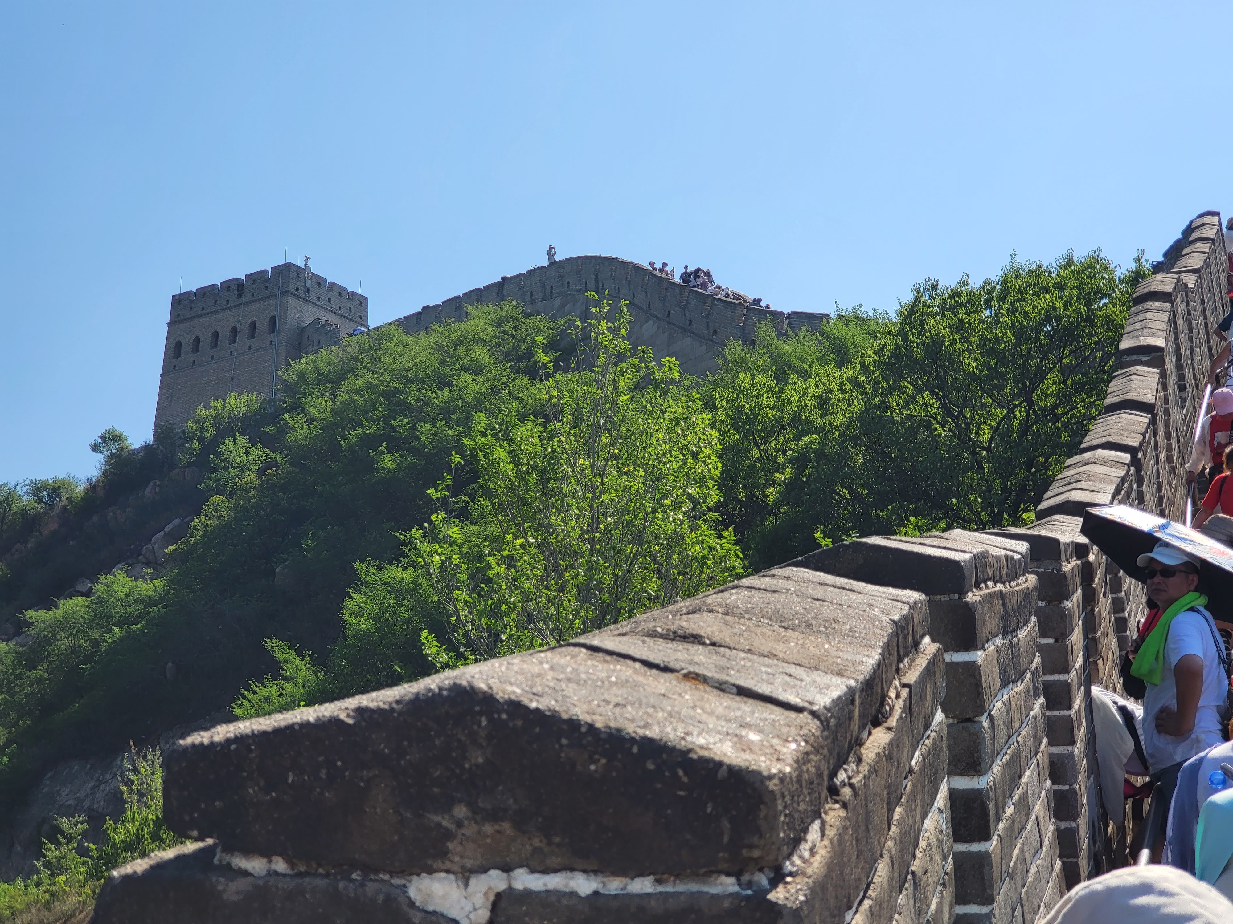 Stone parapets lead uphill toward a square watchtower.