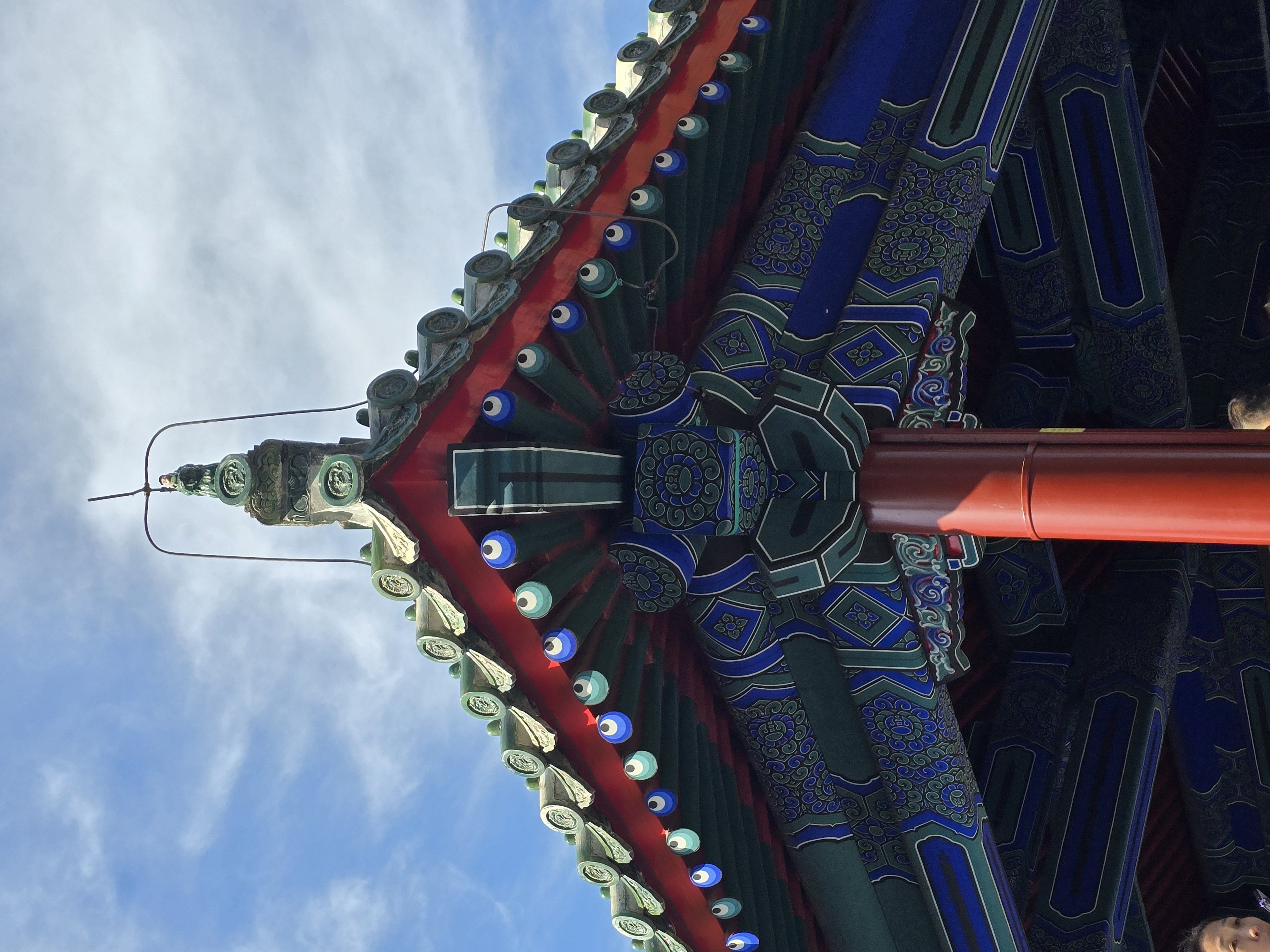 Painted brackets support the curling corner of a temple roof.