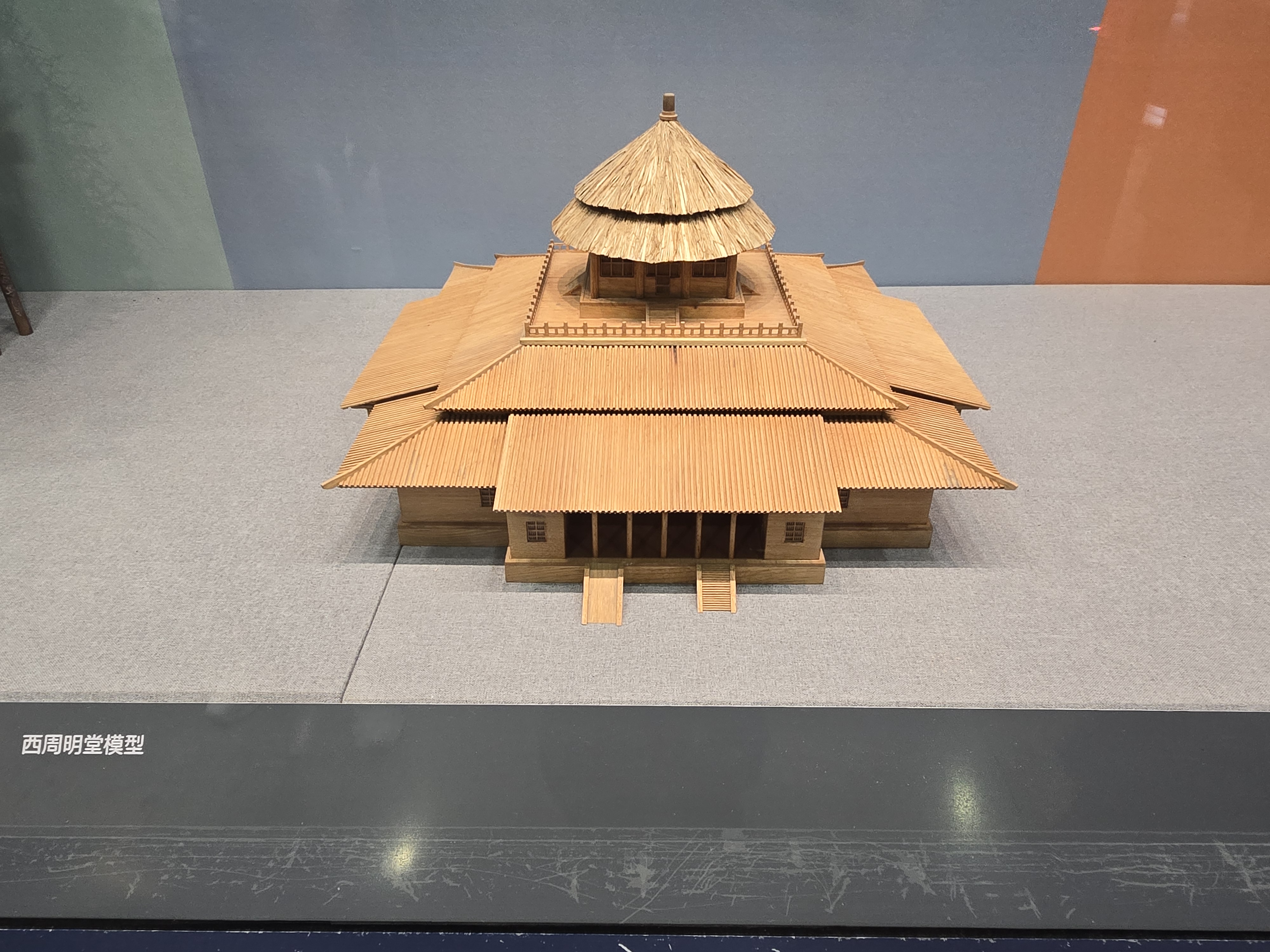 A timber model with a broad stepped roof.