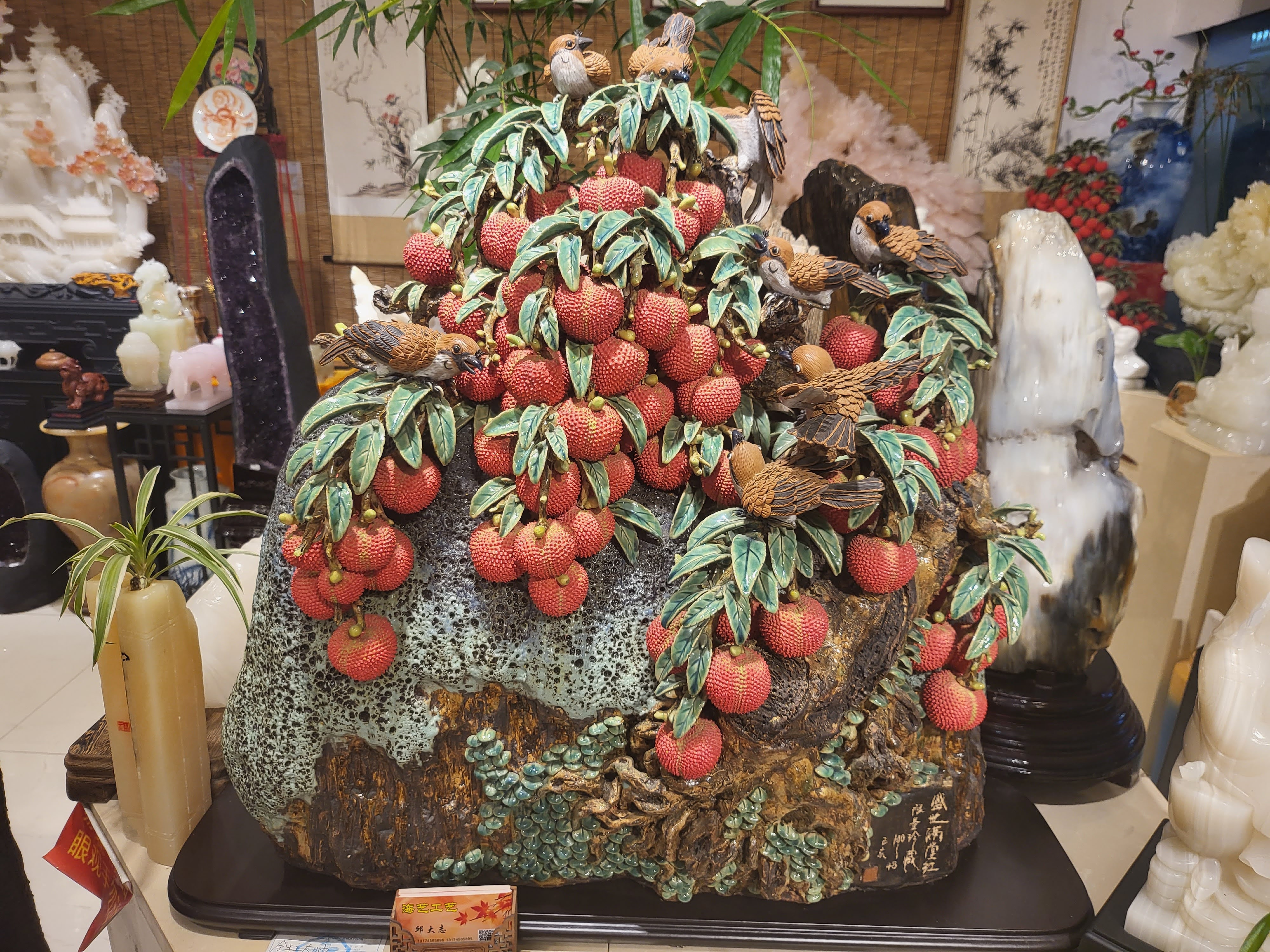 A decorative tree covered with carved fruit.