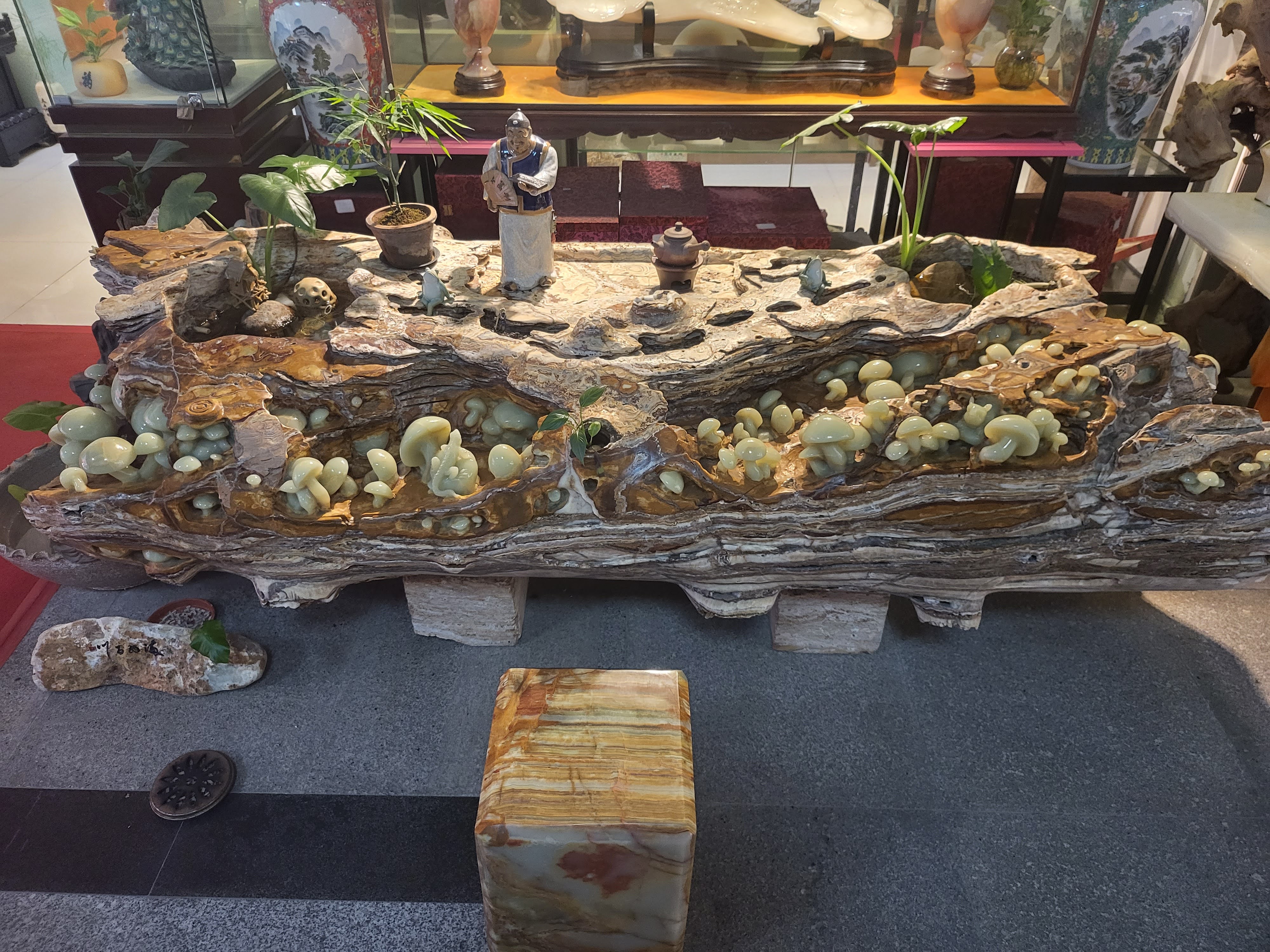 An elaborate miniature landscape crowded with figures and buildings.