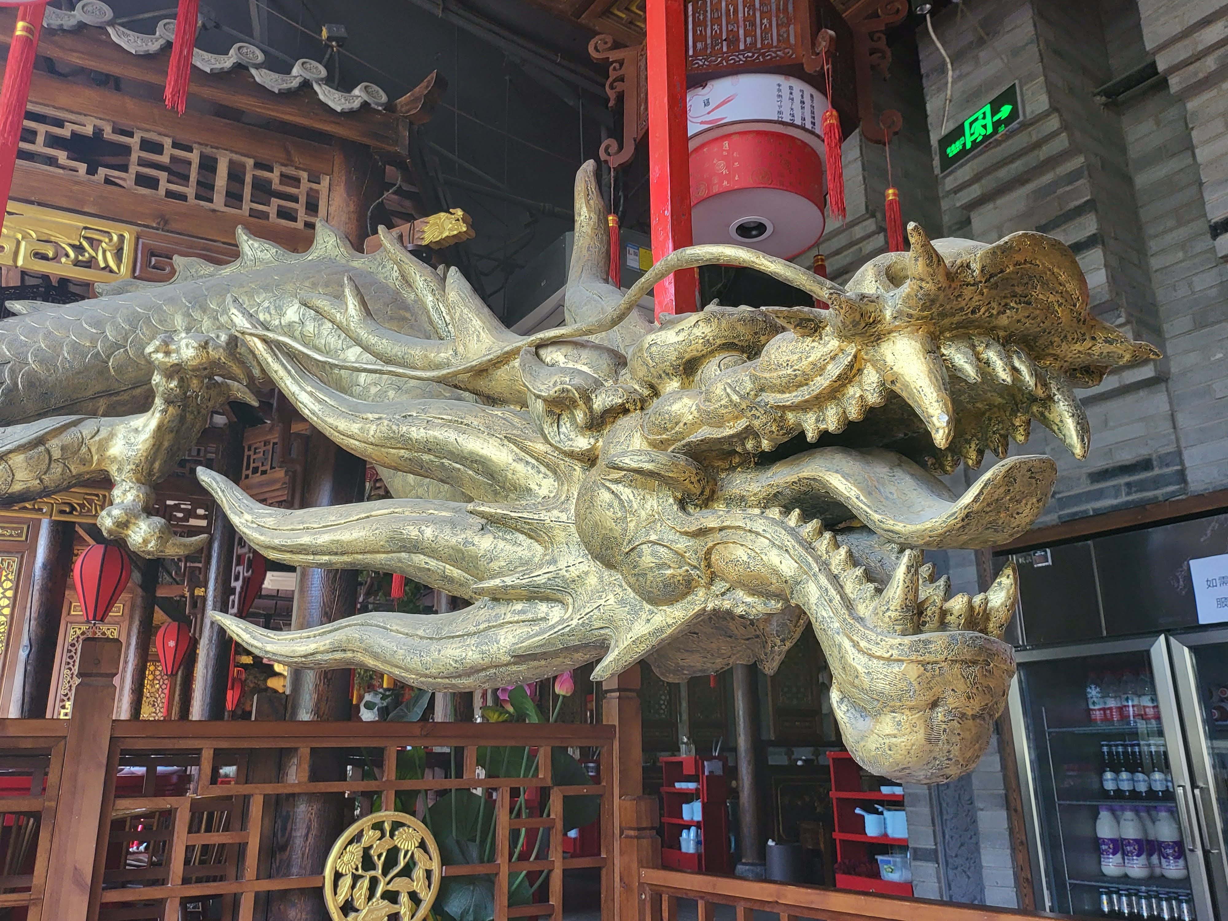 A gilded dragon head projects above the dining room.