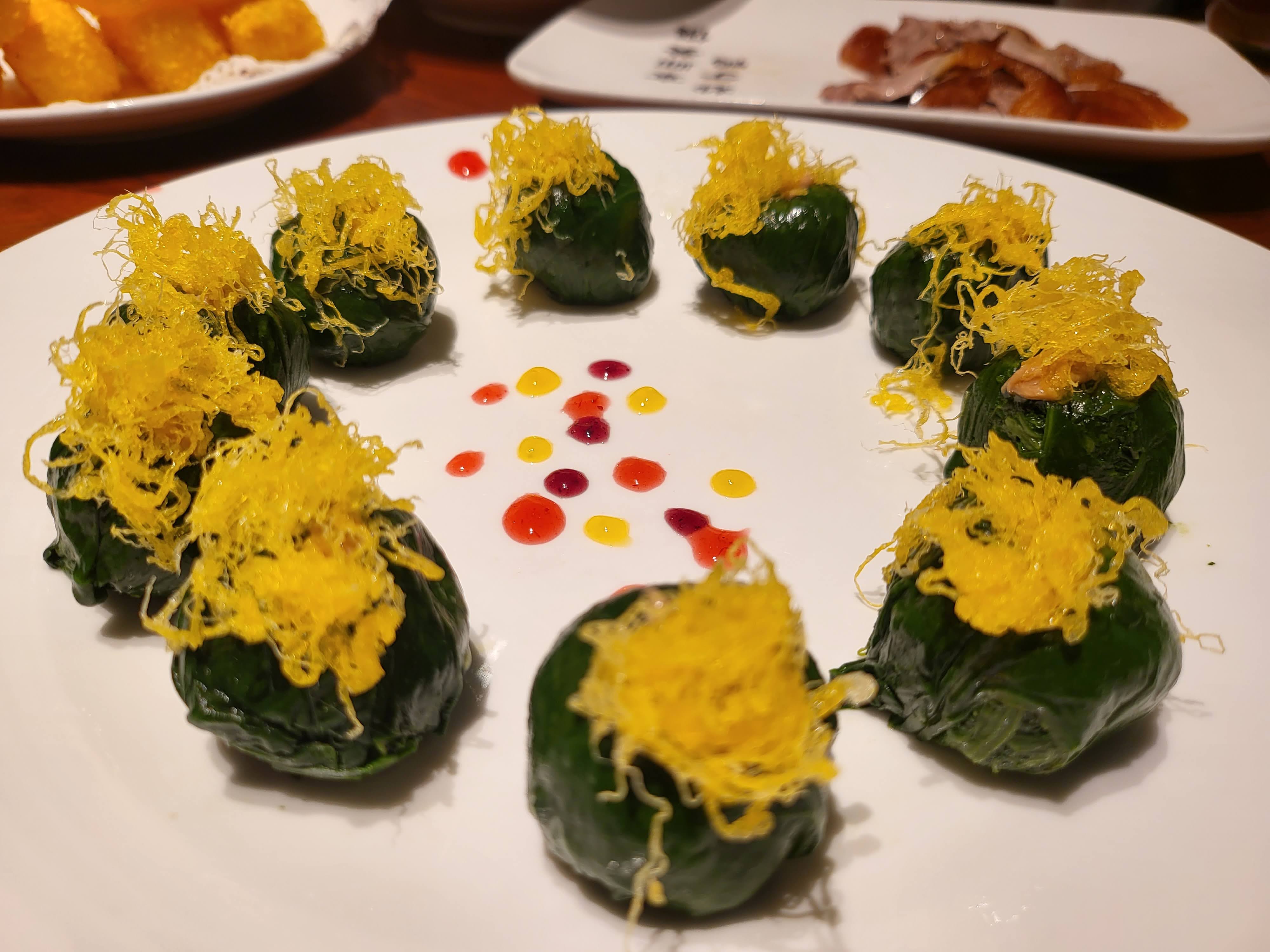 Small bites finished with finely shredded yellow garnish.
