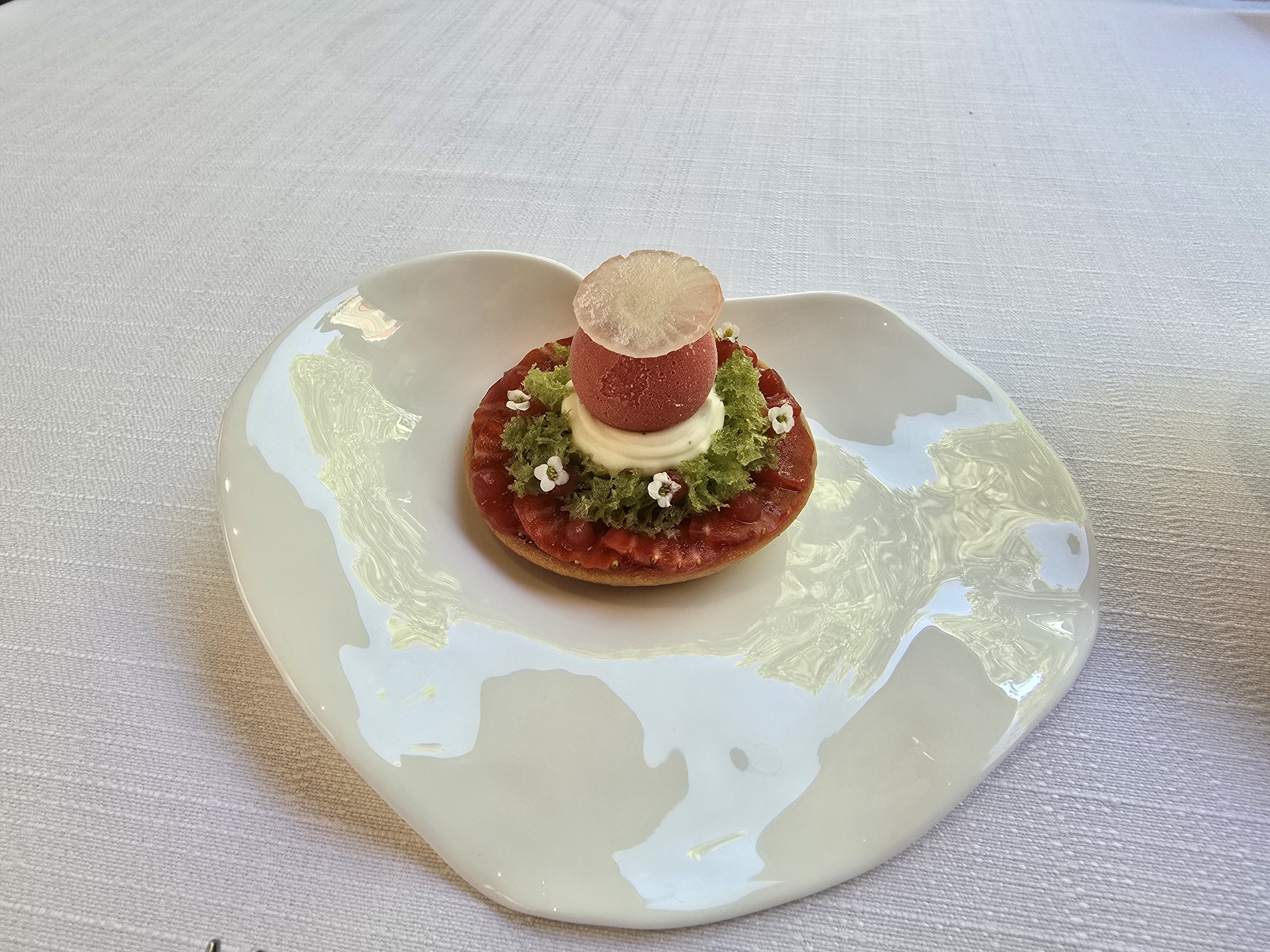 A vanilla tartlet topped with strawberry sorbet.
