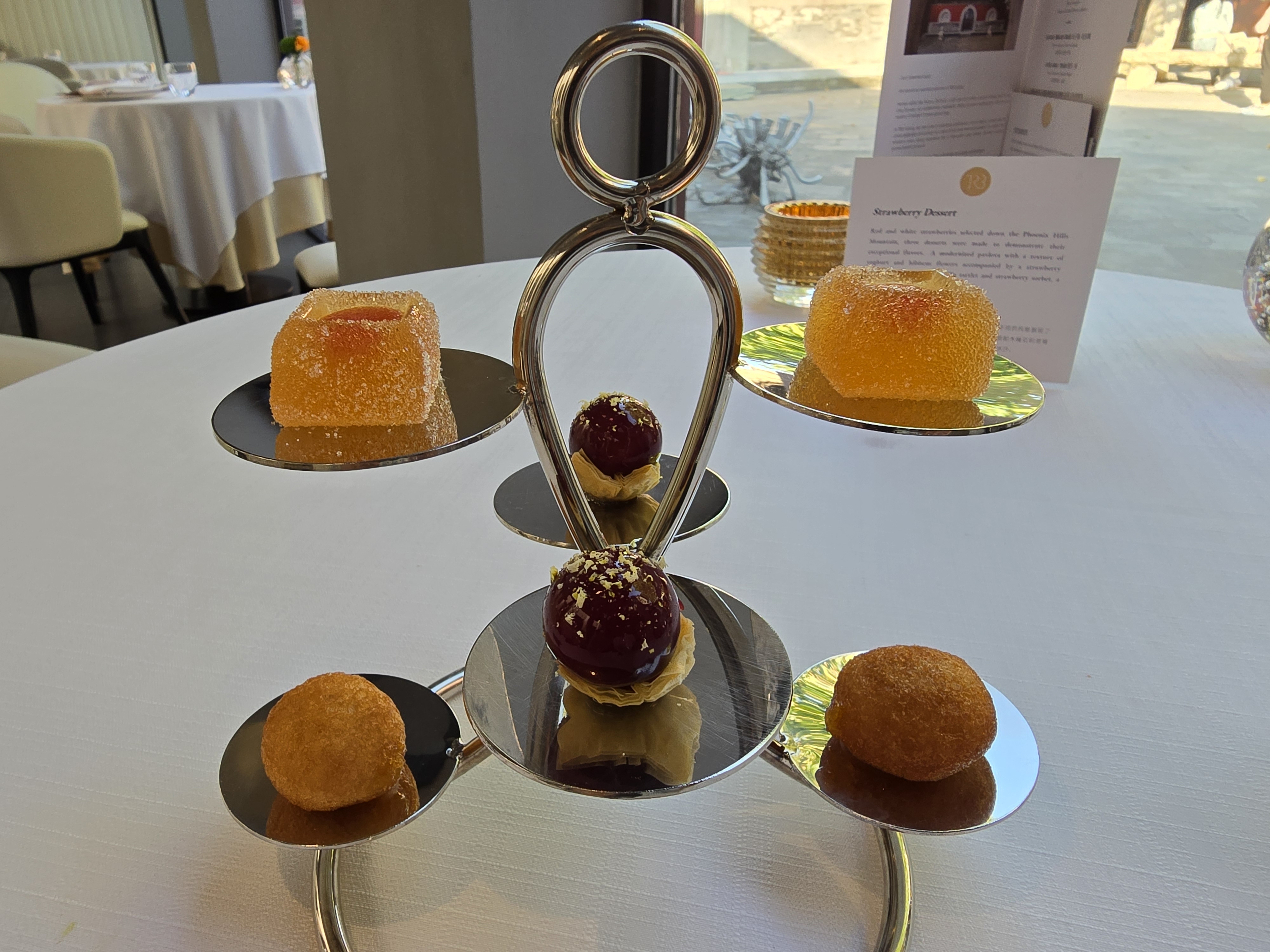 Petits fours arranged on a tiered stand.