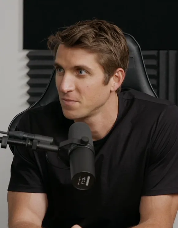 Brett Hagler sitting behind a microphone at a podcast recording session