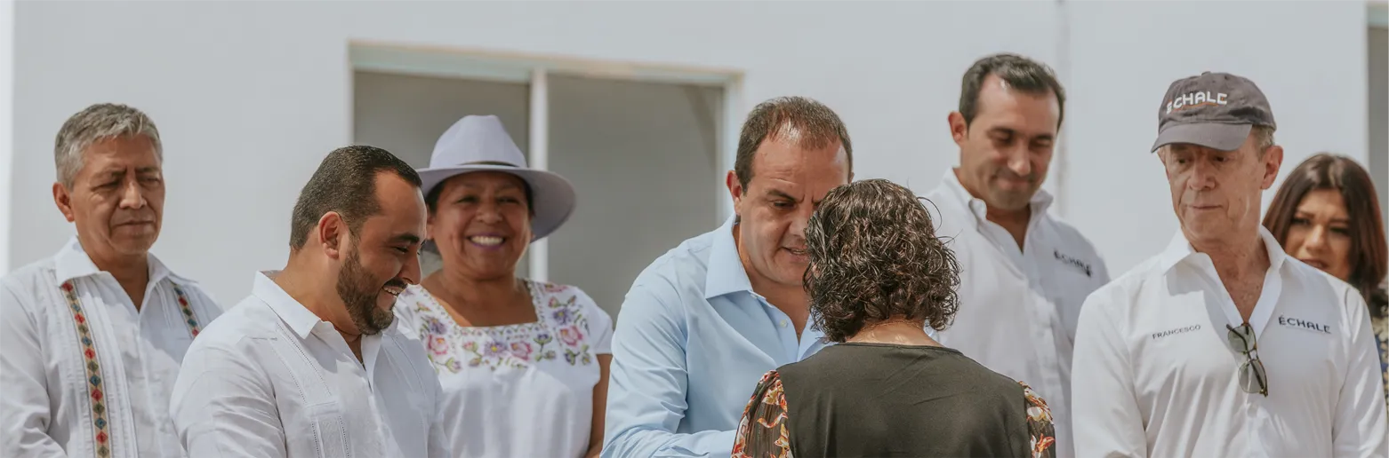8 people standing in a line chatting and smiling