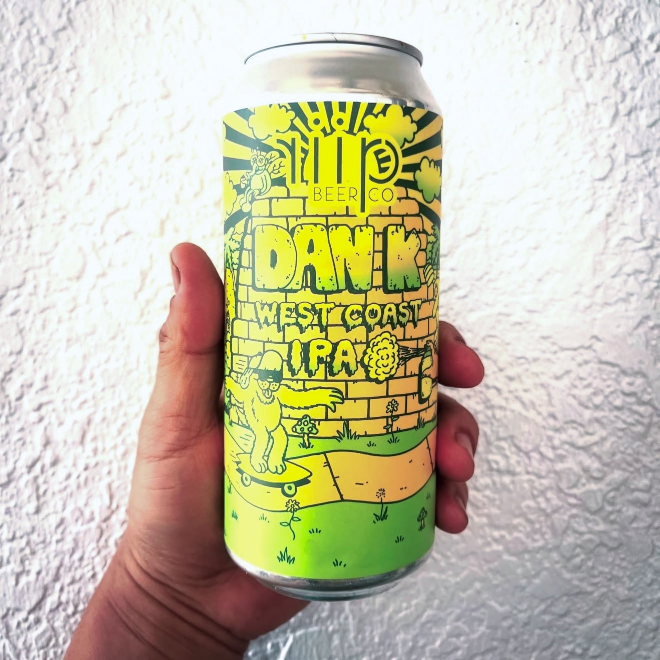Hand holding a bright can of Riip Beer Co's Dan K West Coast IPA 