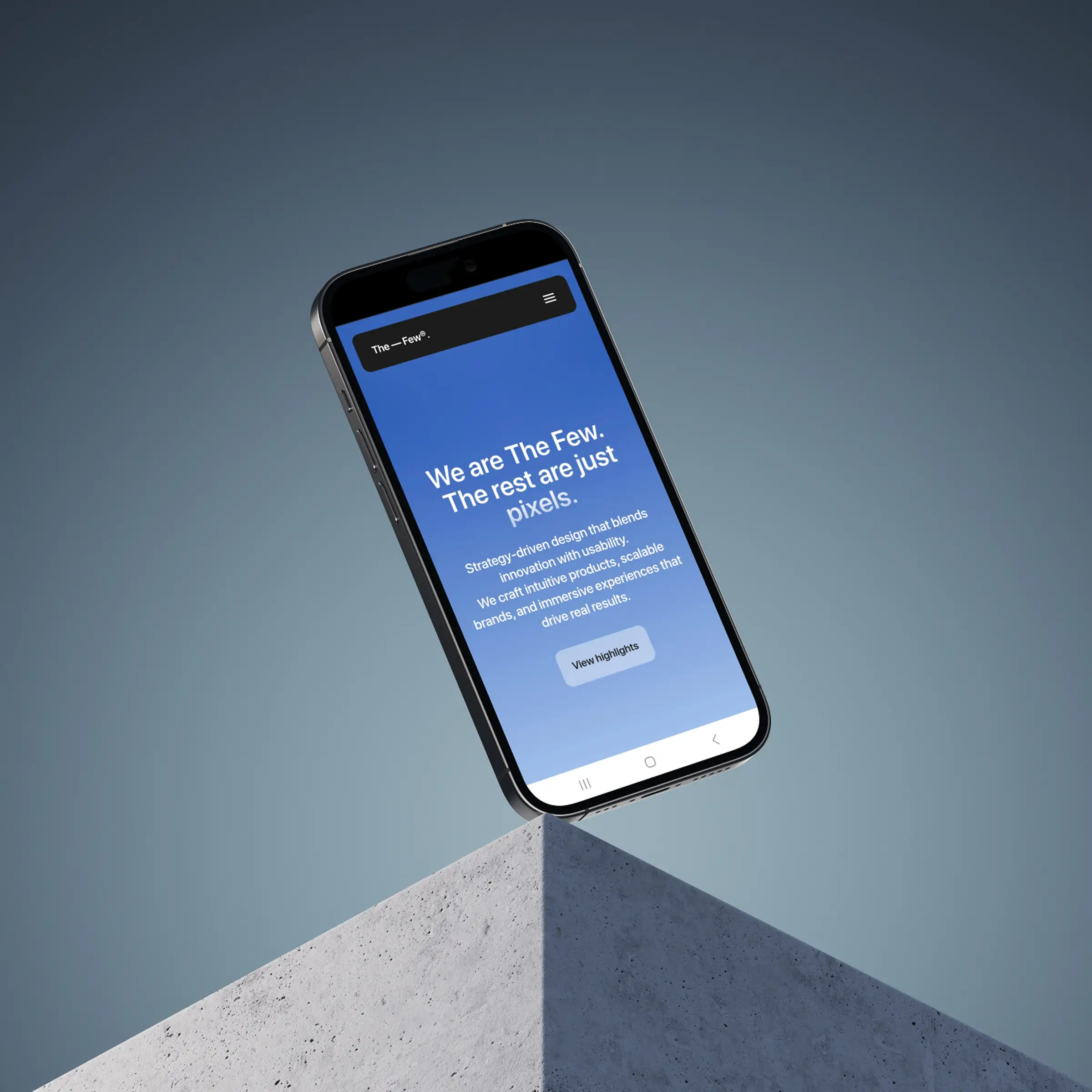A cell phone with The Few website open on screen.