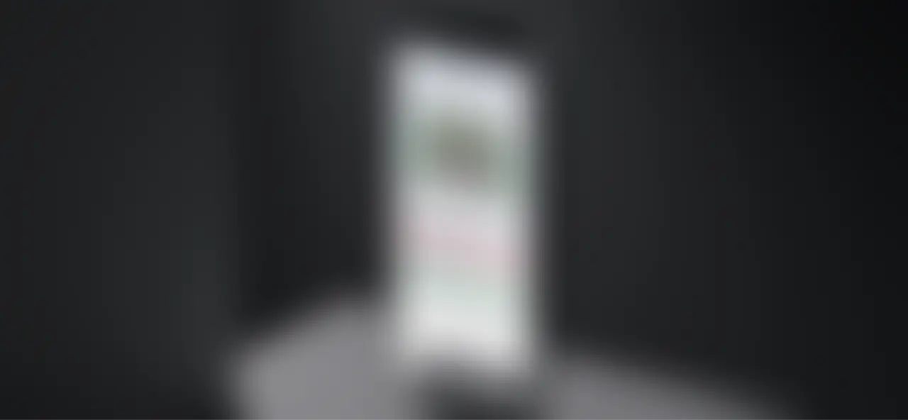 A couple of cell phones sitting next to each other, with the CODE Furniture website open on their screens.