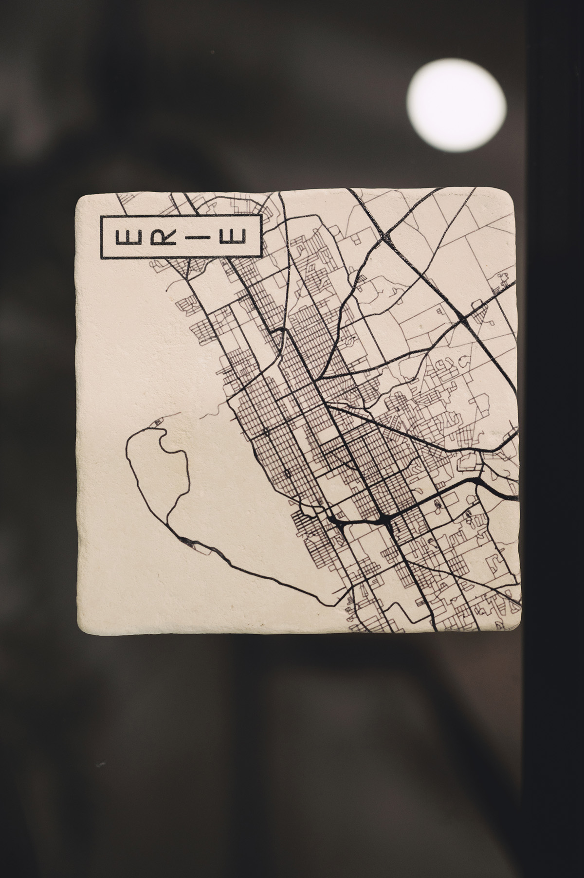 Black and white street map on a square tile with grid layout and bold roads.