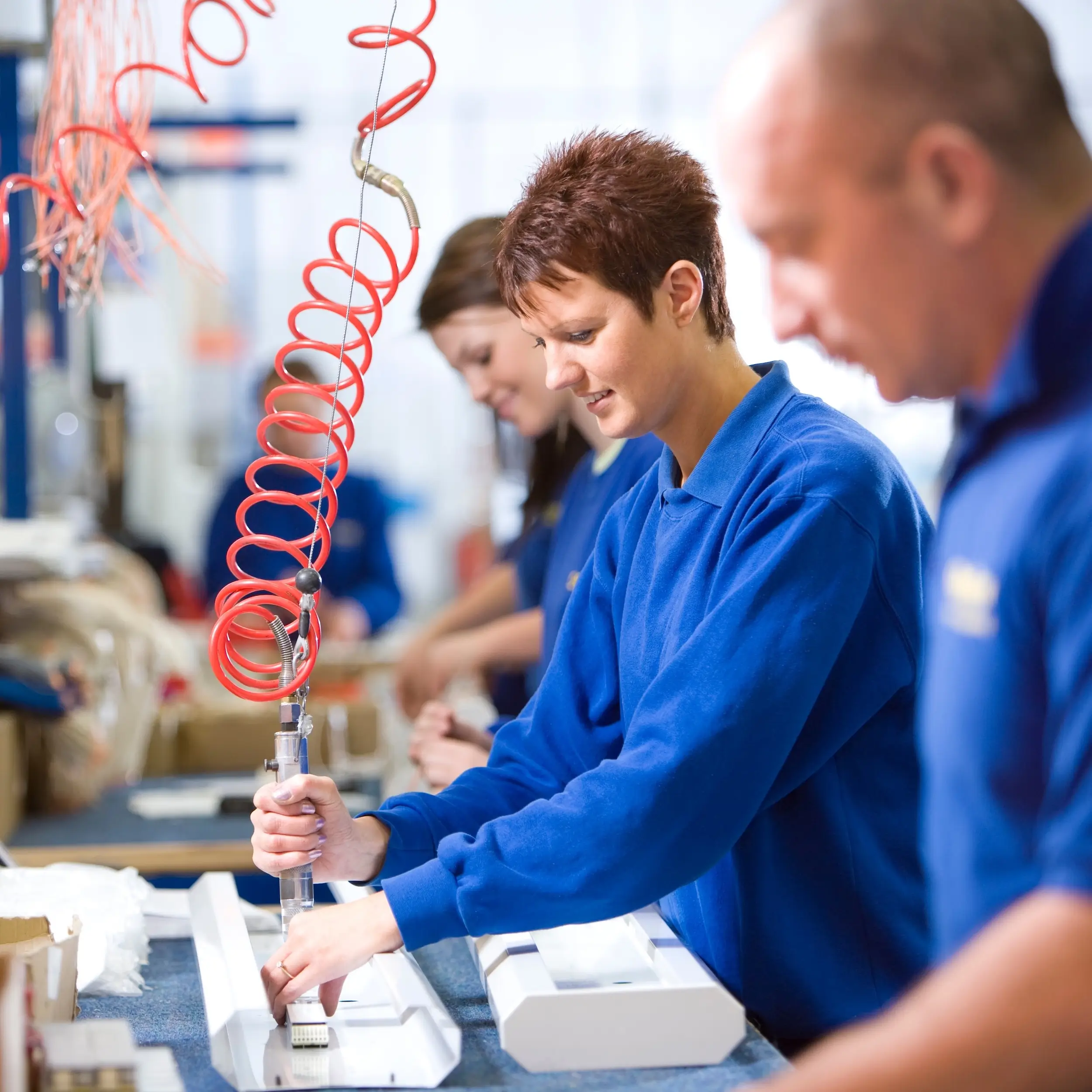 Production line worker operating machine on active shift