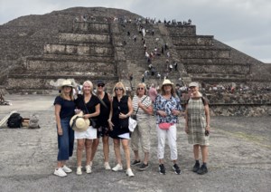 B.C. tourists smile at Mexico pyramid. Behind them, a gunman, moments before killing