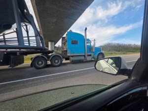 Semi load hits train bridge near Borden