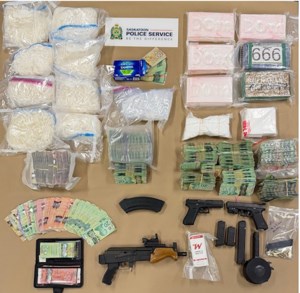 Three charged after police seize drugs, handguns, semi-auto