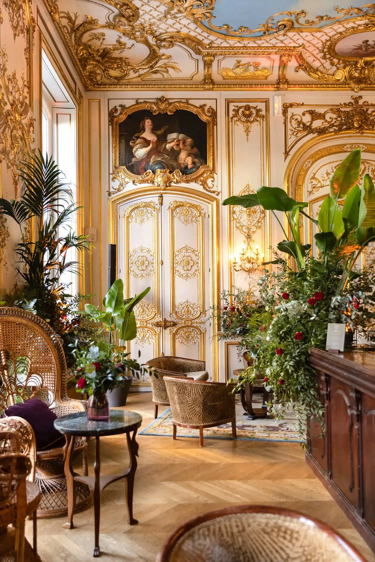 Décor de soirée installé dans un salon doré, orné de compositions florales