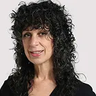 Portrait of a woman with long dark curly hair